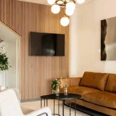 Akoestisch wandpaneel Akoestisch wandpaneel van licht eiken in een woonkamer